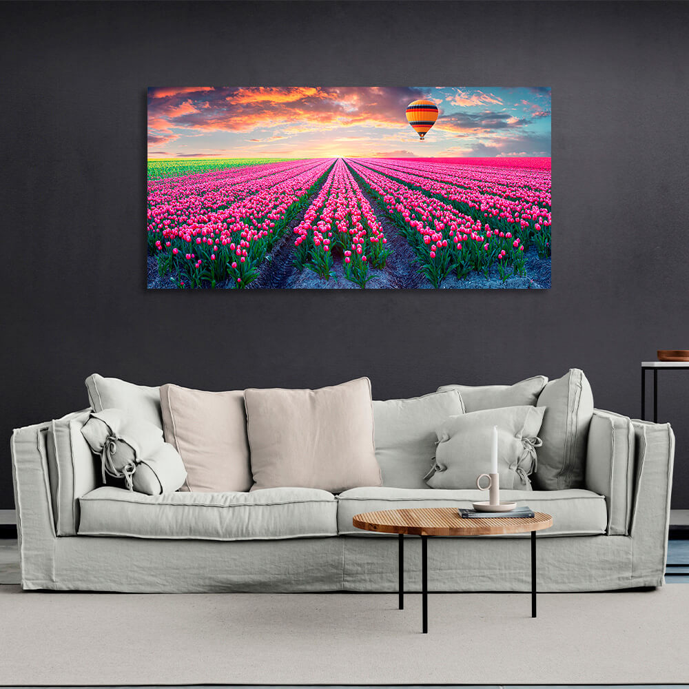 A field of pink tulips against the backdrop of dawn and a hot air balloon Canvas Wall Art Print