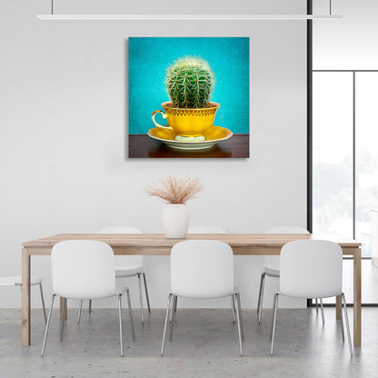 Cactus in cup on saucer on turquoise background Canvas Wall Art Print