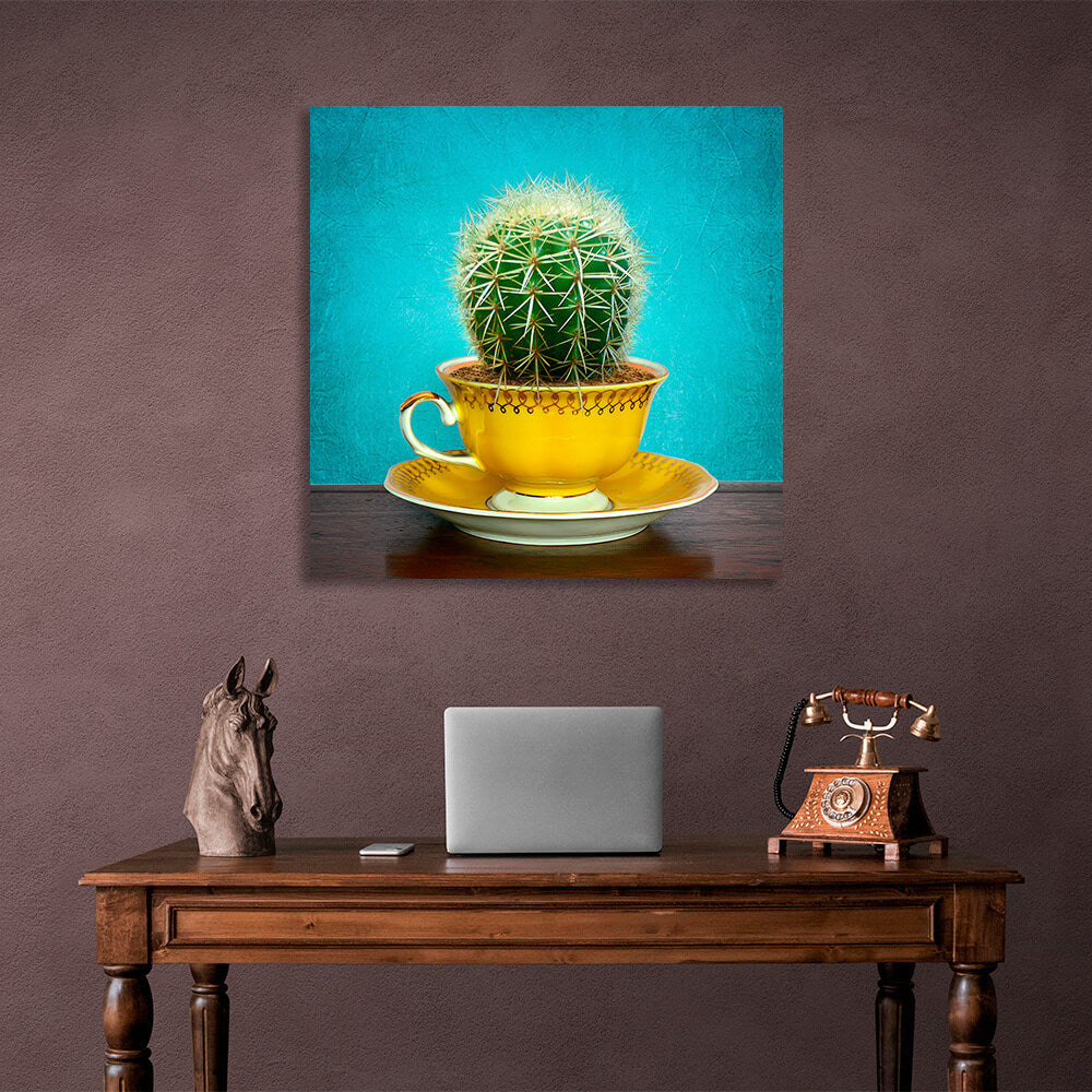 Cactus in cup on saucer on turquoise background Canvas Wall Art Print