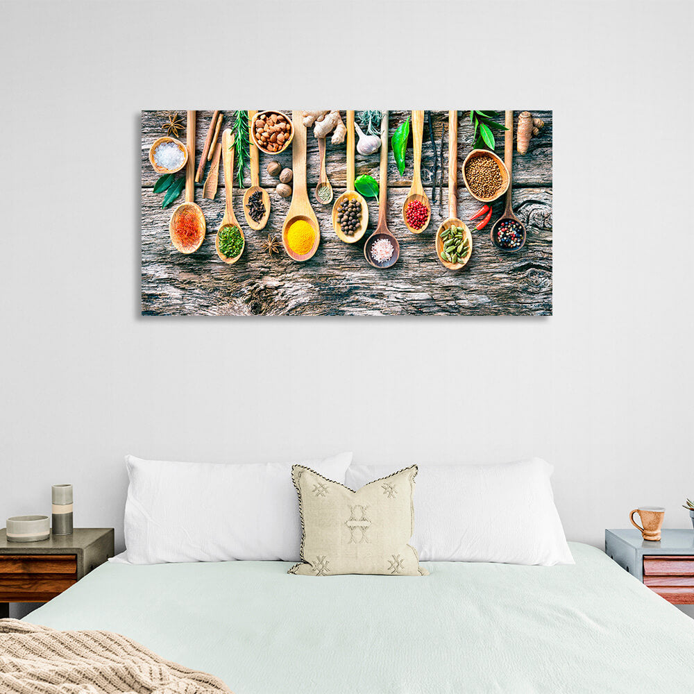 10 spoonfuls of spices on a wooden table with ginger garlic walnuts and pepper Canvas Wall Art Print For Kitchen