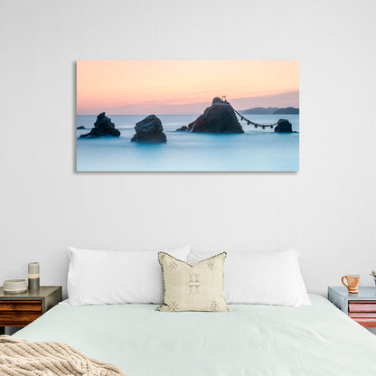 5 rocks in the sea with two mountains in the background Canvas Wall Art Print