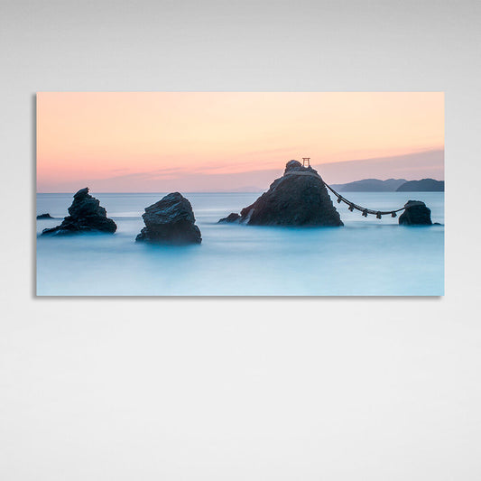 5 rocks in the sea with two mountains in the background Canvas Wall Art Print