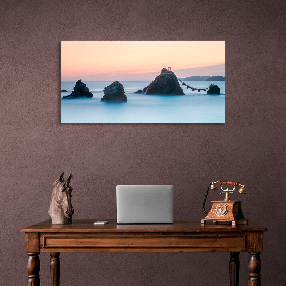 5 rocks in the sea with two mountains in the background Canvas Wall Art Print