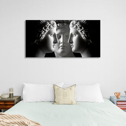 Three antique sculptures on a black background Canvas Wall Art Print