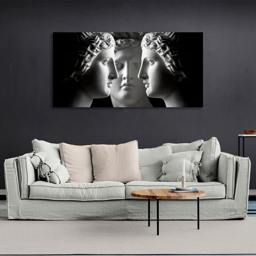 Three antique sculptures on a black background Canvas Wall Art Print