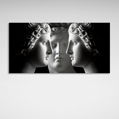 Three antique sculptures on a black background Canvas Wall Art Print