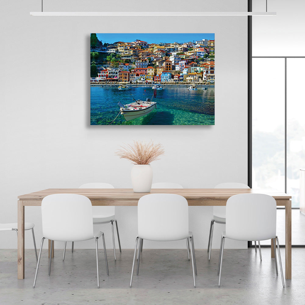 A boat in an incredibly clear sea against the backdrop of a brightly colored city Canvas Wall Art Print