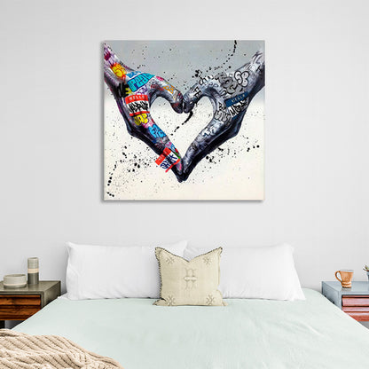 Two hands folded into a heart shape on a gray background in graffiti style Canvas Wall Art Print