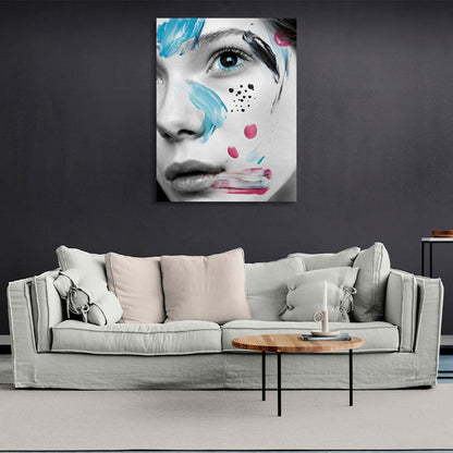 A girl with black eyes with smears of paint on her face Canvas Wall Art Print