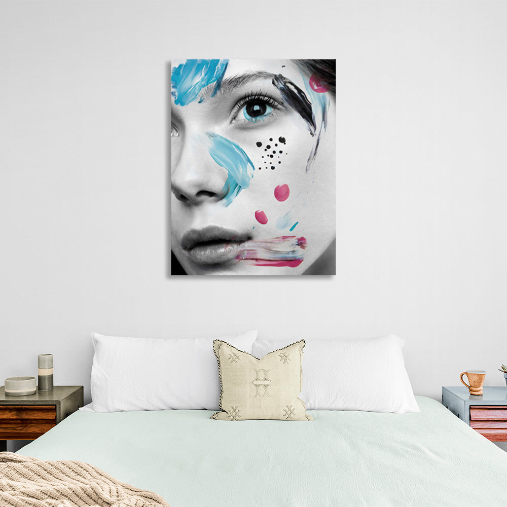 A girl with black eyes with smears of paint on her face Canvas Wall Art Print