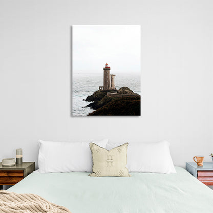 Lighthouse on a rock against the sea Canvas Wall Art Print