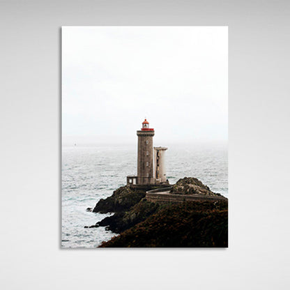 Lighthouse on a rock against the sea Canvas Wall Art Print