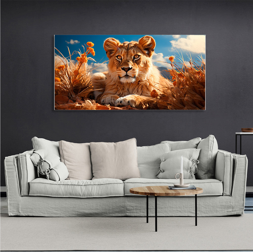 A young lion in the dry grass Canvas Wall Art Print